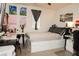 Cozy bedroom with a white platform bed, desk area, and natural light from the window at 777 Star Apple Ln, Las Vegas, NV 89178