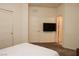 Inviting bedroom showcasing a TV, neutral walls, and convenient access to the en-suite bathroom at 777 Star Apple Ln, Las Vegas, NV 89178