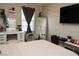 Bedroom featuring a TV, vanity, large mirror and soft natural light from the window at 777 Star Apple Ln, Las Vegas, NV 89178