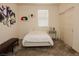 Relaxing bedroom featuring a striped bedspread, decorative artwork, and a bench at 777 Star Apple Ln, Las Vegas, NV 89178
