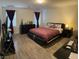 Bedroom features modern platform bed, wood-look flooring, and natural light at 777 Star Apple Ln, Las Vegas, NV 89178