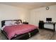 Comfortable bedroom with a well-lit workspace and a comfortable platform bed, perfect for relaxation and productivity at 777 Star Apple Ln, Las Vegas, NV 89178