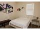 Cozy bedroom with simple decor, a comfortable bed, and a window with blinds at 777 Star Apple Ln, Las Vegas, NV 89178