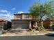 Charming two-story home featuring a brick driveway and a well-manicured front yard at 777 Star Apple Ln, Las Vegas, NV 89178