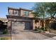 Charming two-story home featuring a red brick driveway, attached garage, and welcoming front porch at 777 Star Apple Ln, Las Vegas, NV 89178