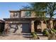 Charming two-story home featuring a red brick driveway, attached garage, and welcoming front porch at 777 Star Apple Ln, Las Vegas, NV 89178