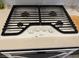 Modern gas range top with four burners, white finish, and black grates for a sleek kitchen aesthetic at 777 Star Apple Ln, Las Vegas, NV 89178