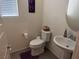 Powder room features modern fixtures, gray vinyl flooring, and a decorative wall hanging at 777 Star Apple Ln, Las Vegas, NV 89178