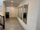 Hallway with neutral tile, access to stairs, and decorated with large mirrors at 777 Star Apple Ln, Las Vegas, NV 89178