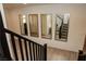 Bright hallway featuring a staircase and a series of mirrors, enhancing the sense of space and modern design at 777 Star Apple Ln, Las Vegas, NV 89178