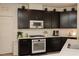 Modern kitchen showcasing dark cabinetry, stainless steel oven, and white countertops at 777 Star Apple Ln, Las Vegas, NV 89178