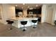 Kitchen with quartz countertops, island, dark cabinets, and stainless steel appliances at 777 Star Apple Ln, Las Vegas, NV 89178