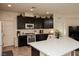 Spacious kitchen with dark cabinetry, stainless steel appliances, and an oversized island at 777 Star Apple Ln, Las Vegas, NV 89178