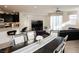 Open-concept living area featuring modern furniture, a ceiling fan, and a seamless transition to the dining area at 777 Star Apple Ln, Las Vegas, NV 89178