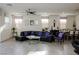 Open living area featuring modern furnishings, including a black sectional sofa and glass coffee table at 777 Star Apple Ln, Las Vegas, NV 89178