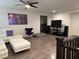 Bright living room featuring sectional sofa, modern decor, ceiling fan, and wood flooring at 777 Star Apple Ln, Las Vegas, NV 89178
