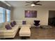 Inviting living room featuring sectional sofa, modern decor, ceiling fan, and contemporary flooring at 777 Star Apple Ln, Las Vegas, NV 89178