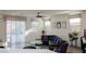 Living area with black leather sofa, modern art, and sliding glass doors to let in natural light at 777 Star Apple Ln, Las Vegas, NV 89178