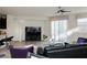 Bright living room featuring tile floors, a modern sofa, and sliding glass doors to the patio at 777 Star Apple Ln, Las Vegas, NV 89178