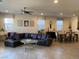 An open living space with a comfortable leather sofa, natural light, and ceiling fan at 777 Star Apple Ln, Las Vegas, NV 89178