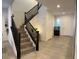 Open staircase with wood-look steps and dark wood railings leading to upper level with bright interior at 777 Star Apple Ln, Las Vegas, NV 89178