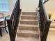 Elegant staircase with wood-look steps and dark wood railings leading to upper floors of the home at 777 Star Apple Ln, Las Vegas, NV 89178