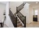 Elegant staircase with dark railings and neutral steps, complemented by a decorative aquarium at 777 Star Apple Ln, Las Vegas, NV 89178