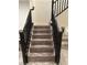 Elegant staircase featuring dark wood railings and light wood stairs at 777 Star Apple Ln, Las Vegas, NV 89178