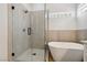 Modern bathroom featuring a glass-enclosed shower and a soaking tub near a window at 8312 Raphael Ct, Las Vegas, NV 89129