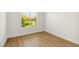 Bright, empty bedroom with hardwood floors and a large window at 8312 Raphael Ct, Las Vegas, NV 89129