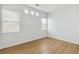 Bright and airy bedroom with lots of natural light and wood-look floors at 8312 Raphael Ct, Las Vegas, NV 89129