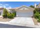 Charming single story home featuring a two-car garage, tile roof, and colorful landscaping at 8312 Raphael Ct, Las Vegas, NV 89129