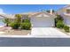 Charming single story home featuring a two-car garage, tile roof, and colorful landscaping at 8312 Raphael Ct, Las Vegas, NV 89129