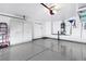 Spacious garage featuring storage cabinets and clean epoxy flooring at 8312 Raphael Ct, Las Vegas, NV 89129