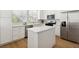 Well-lit kitchen with white cabinets, stainless steel appliances, and center island at 8312 Raphael Ct, Las Vegas, NV 89129