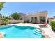 Inviting backyard featuring a private pool, lounge chair, and mature landscaping at 8312 Raphael Ct, Las Vegas, NV 89129