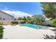 Beautiful backyard pool with lounge chairs and well-manicured landscaping at 8312 Raphael Ct, Las Vegas, NV 89129