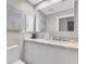 Clean bathroom featuring a vanity, marble countertop, a white toilet, and a decorative plant at 8370 Plum Creek Ct, Las Vegas, NV 89113