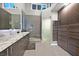 Modern bathroom featuring a glass shower, double vanity, and custom storage cabinets at 8370 Plum Creek Ct, Las Vegas, NV 89113