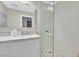 Modern bathroom featuring a single vanity and a glass walk-in shower with stone floor at 8370 Plum Creek Ct, Las Vegas, NV 89113