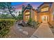 Inviting front courtyard features outdoor seating, desert landscaping, and a walkway leading to the home's entry at 8370 Plum Creek Ct, Las Vegas, NV 89113