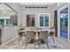 Contemporary dining room boasts stylish lighting, art, and sliding glass doors to outdoor space at 8370 Plum Creek Ct, Las Vegas, NV 89113