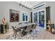 Elegant dining room with modern lighting, a large poster, and sliding doors to the backyard at 8370 Plum Creek Ct, Las Vegas, NV 89113