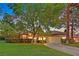 Inviting single-story home with mature trees, a lush lawn, and a two-car garage, creating a warm and welcoming curb appeal at 8370 Plum Creek Ct, Las Vegas, NV 89113