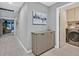 Hallway view of a modern cabinet with a light gray color and a laundry room on the other end of the hallway at 8370 Plum Creek Ct, Las Vegas, NV 89113