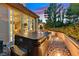Back patio featuring a relaxing hot tub, lush foliage, and access to the home's interior at 8370 Plum Creek Ct, Las Vegas, NV 89113