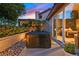 Secluded outdoor hot tub with stone accents and lush landscaping, perfect for relaxation and privacy at 8370 Plum Creek Ct, Las Vegas, NV 89113