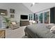 Large main bedroom with vaulted ceilings, cozy seating area, gray walls, and neutral carpeting at 8370 Plum Creek Ct, Las Vegas, NV 89113