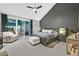 Main bedroom features a ceiling fan, vaulted ceiling, and sliding glass doors out to the patio at 8370 Plum Creek Ct, Las Vegas, NV 89113