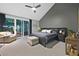 Spacious main bedroom featuring dark gray walls, vaulted ceilings, and sliding glass doors to a patio at 8370 Plum Creek Ct, Las Vegas, NV 89113